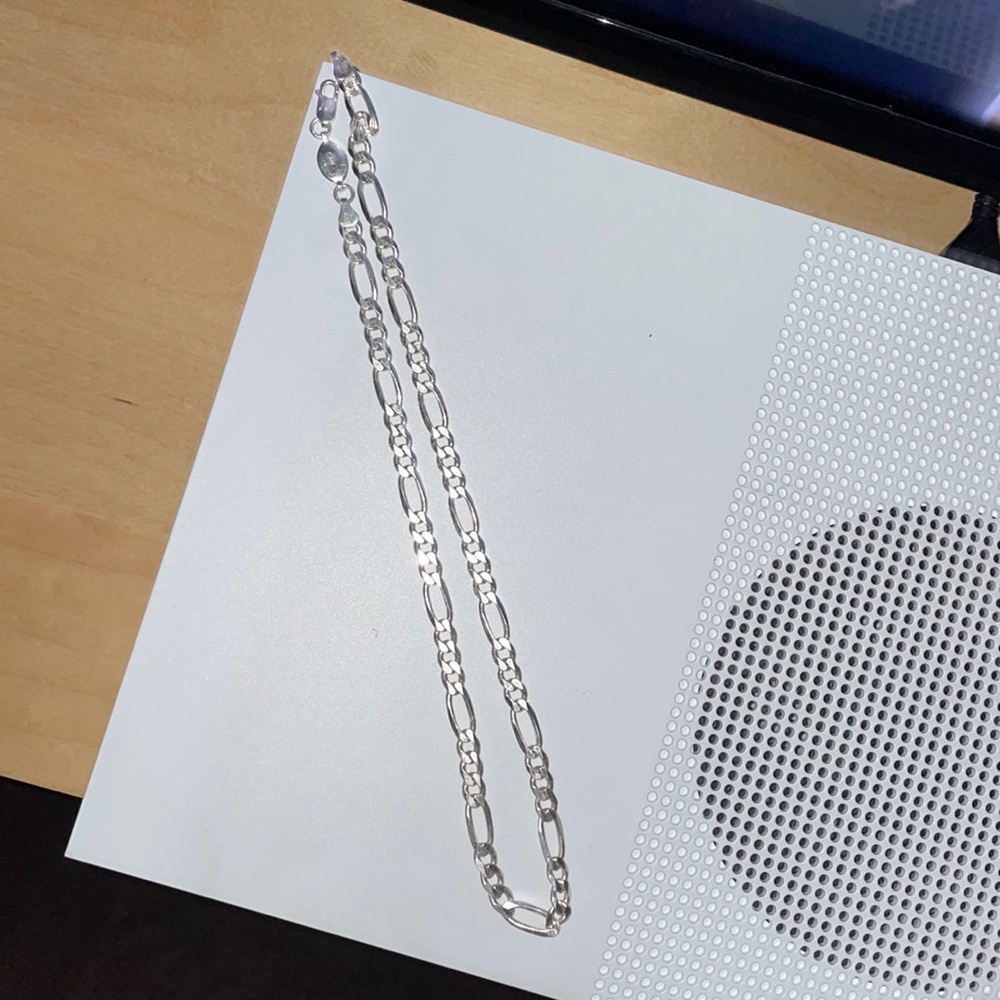 It’s a diamond cut, sterling silver, Figaro chain.